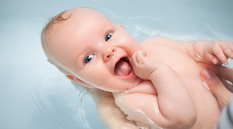 happy baby enjoying a bath